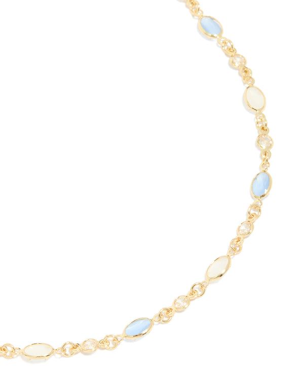 Crafted from gold plated material, this blue and white oval cubic zirconia necklace in dainty style close up view
