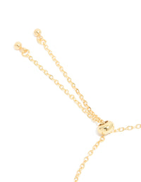 Featuring the toggle mechanism of a gold plated blue and beige oval cubic zirconia bracelet on closure detail view - link has visual effect only
