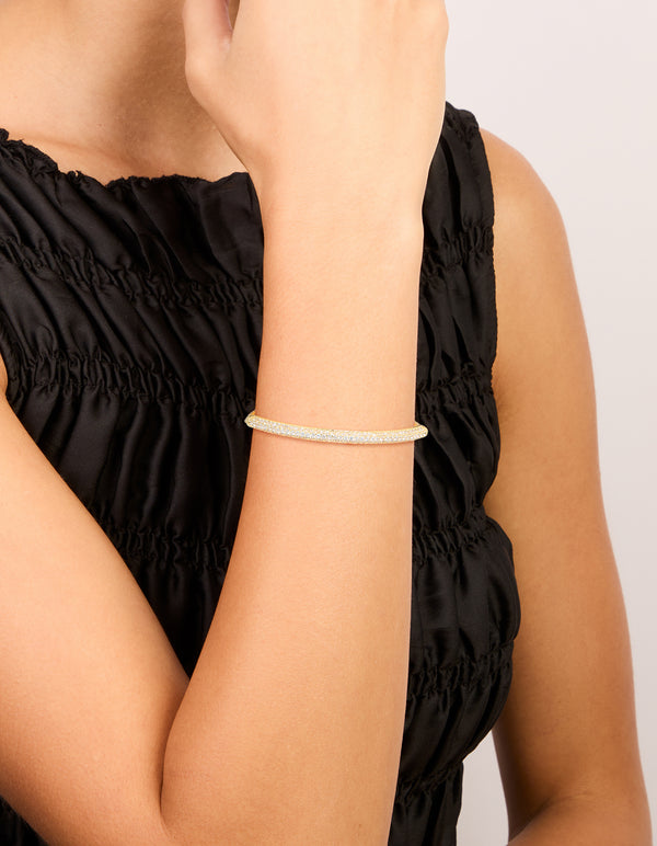Showcasing a gold plated cubic zirconia pavé toggle bracelet with adjustable fastening on wrist view
