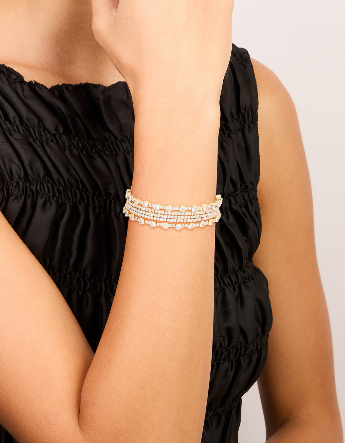 Featuring a gold mini bezel set wrist cuff crafted from cubic zirconia on wrist view