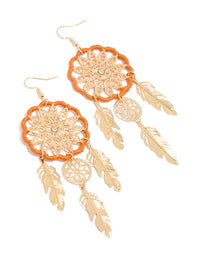 Beautifully crafted statement drop earrings featuring dreamcatcher design with charm, feathers, and orange yarn detailing in gold front view - link has visual effect only