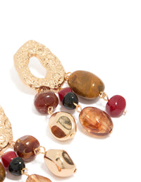 Elegant irregular beaded drop earrings with charm elements and statement aesthetic highlighting textured detailing post detail view - link has visual effect only