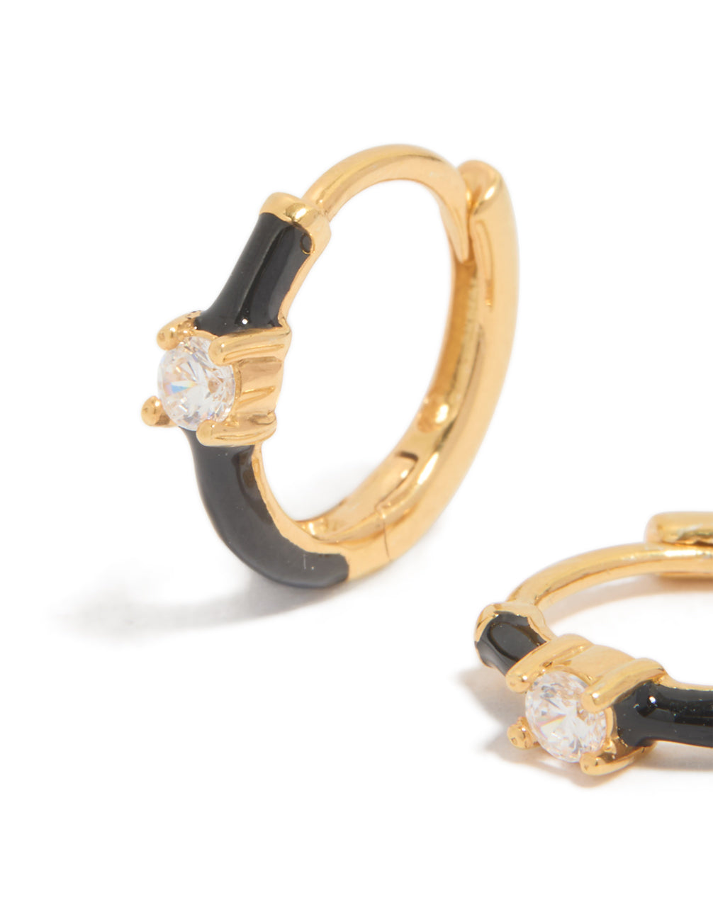 Elegant gold plated sterling silver cubic zirconia and black enamel huggie earrings with hoop closure close up view