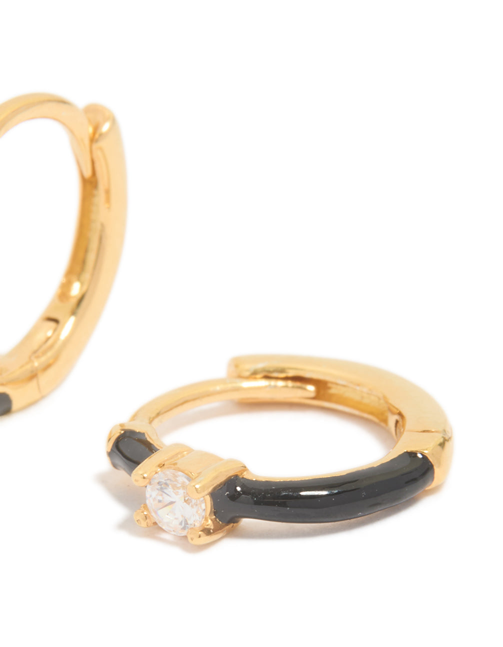 Showcasing gold plated sterling silver cubic zirconia and black enamel huggie earrings featuring hoop closure post detail view