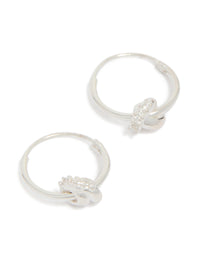 Showcasing sterling silver cubic zirconia knotted hoop earrings with a polished finish in front view - link has visual effect only