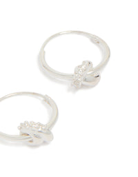 Featuring sterling silver cubic zirconia knotted hoop earrings with detailed craftsmanship in close up view - link has visual effect only