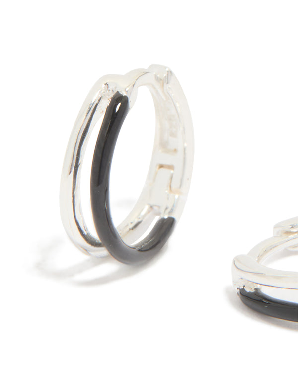 Featuring statement hoop earrings made from sterling silver with black enamel detail close up view