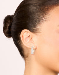 Elegant rose gold plated cubic zirconia leaf hoop earrings worn on ear displaying medium size and placement on ear view - link has visual effect only