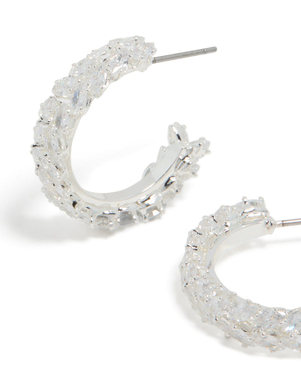 Showcasing medium leaf hoop earrings with cubic zirconia in silver plated finish close up view