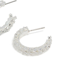 Crafted from silver plated material, these medium leaf hoop earrings feature cubic zirconia post detail view - link has visual effect only