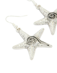 Exquisite antique silver swirl starfish hook earrings with ocean details in a close up view - link has visual effect only