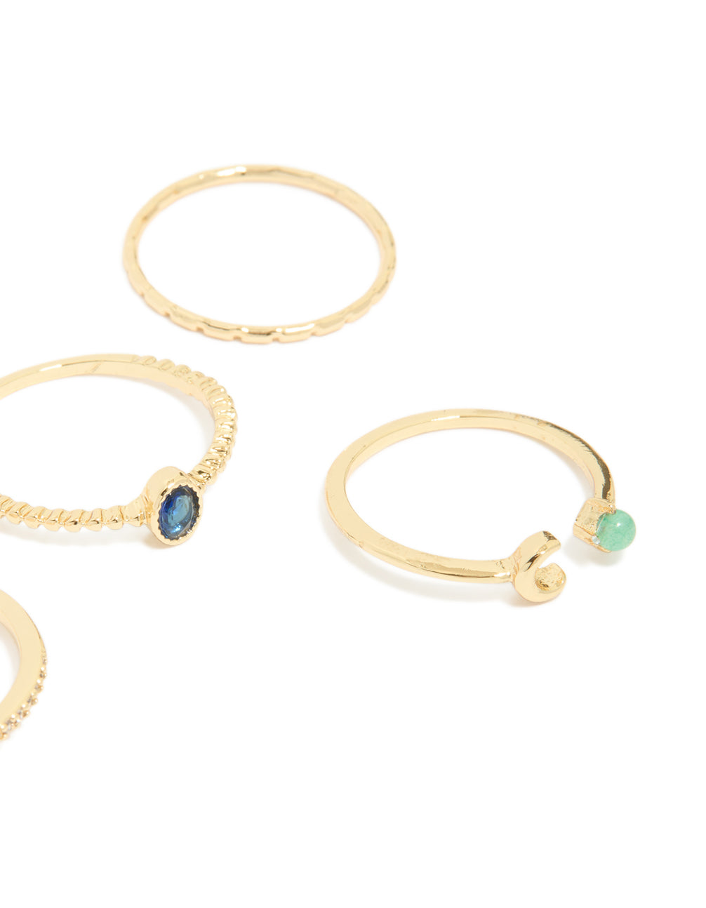 Showcasing gold plated celestial rings with moon, star and blue and clear cubic zirconia accents close up view