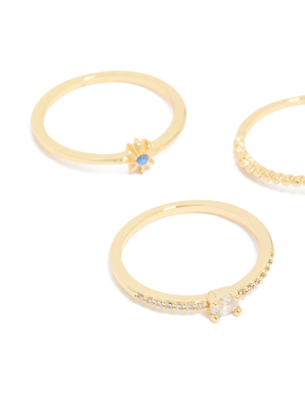 Detailed angle of gold plated celestial rings highlighting star and moon with blue and clear cubic zirconia stones side detail view