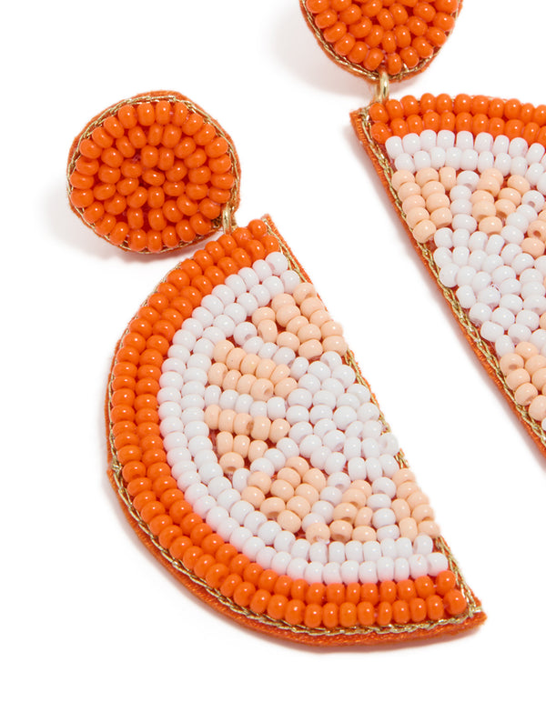 Showcasing orange seed beaded fruit drop earrings with statement style in white, peachpuff, and gold close up view