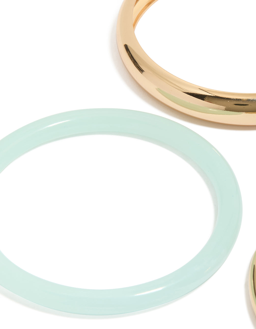 Showcasing gold and blue acrylic stackable bangle bracelets in a 4-pack close up view