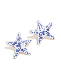 Discover these painted starfish stud earrings featuring floral and ocean motifs in white and blue front view - link has visual effect only