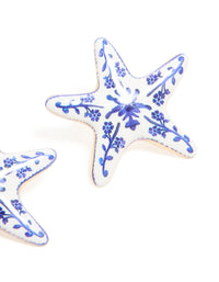 Designed with painted starfish stud earrings featuring floral and ocean accents in white and blue close up view - link has visual effect only