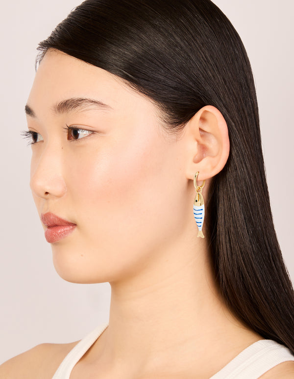 Featuring statement fish huggie earrings with a striped pattern and ocean theme, model view