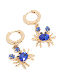 Featuring gold dark blue diamante crab huggie earrings closure and ocean inspired design front view - link has visual effect only