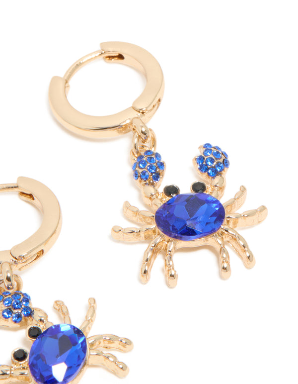 Crafted with gold dark blue diamante crab earrings featuring huggie closure and ocean inspired design post detail view