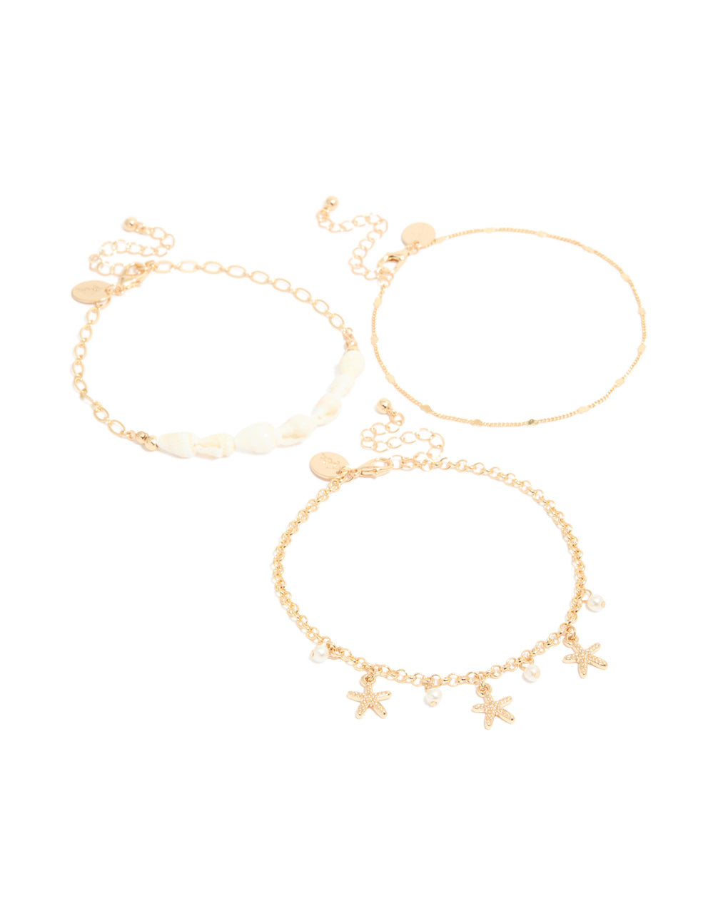 Featuring gold shell and starfish anklets 3-pack with ocean-inspired charm details and pearls front view