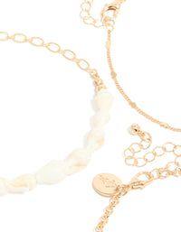 Crafted with gold shell and starfish ocean-inspired charm details and pearls 3-pack anklets side view - link has visual effect only