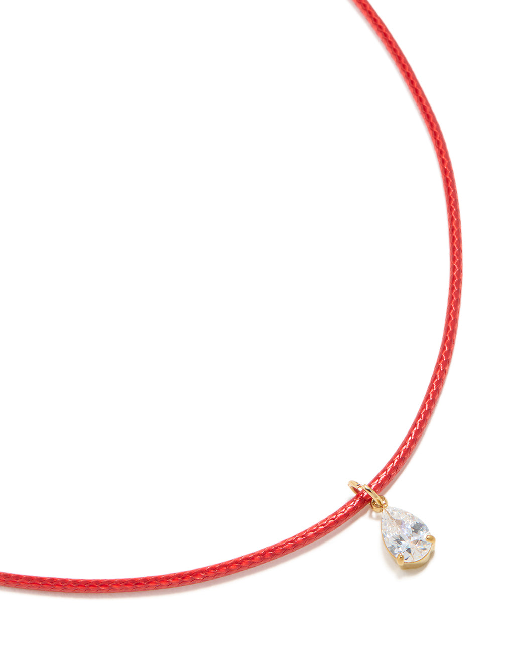Showcasing a pear cut crystal cubic zirconia waterproof gold plated stainless steel necklace with pendant on red cord close up view