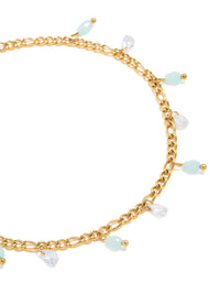 Showcasing a waterproof gold plated stainless steel anklet with aqua beaded and cubic zirconia droplet charms close up view - link has visual effect only