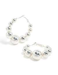 Discover these statement hoop earrings featuring balls in silver front view - link has visual effect only