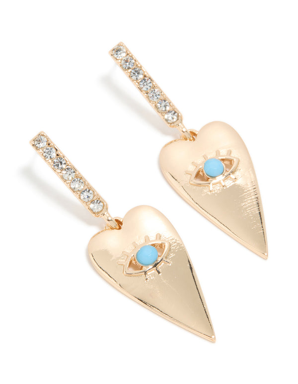 Discover these gold huggie earrings featuring heart with blue evil eye detailing and diamante embellishments front view