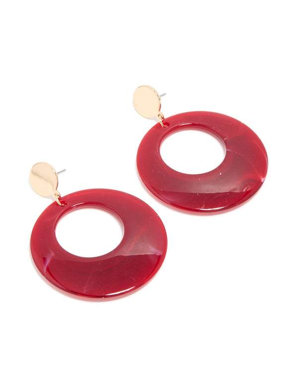 Showcasing statement drop earrings with marble pattern in crimson, maroon, and gold featuring front view