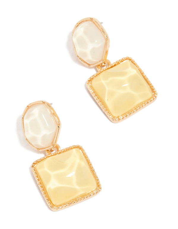 Showcasing statement drop earrings in gold with organic yellow and neutral pool effect featuring round and square shapes front view