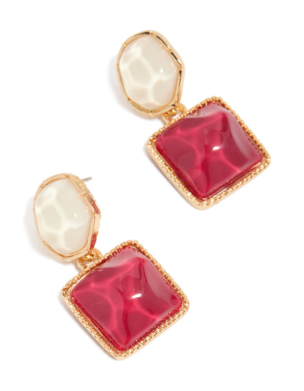 Showcasing statement drop earrings with organic red pool effect round and square charms in gold front view