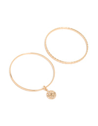 Designed with disc features in gold, this textured bangle 2-pack front view - link has visual effect only