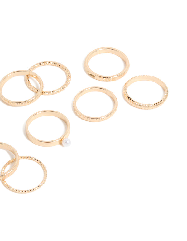 Crafted from gold with pearl embellishments, this simple stackable statement ring 10-pack highlights textured band craftsmanship side view