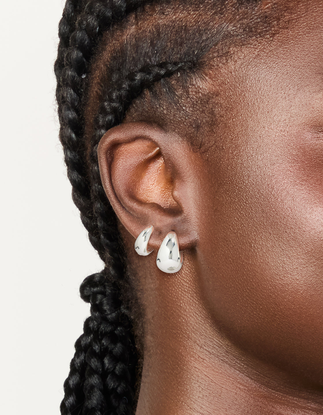 Featuring silver plated bubble huggie earrings with huggie closure in a 2-pack on ear view