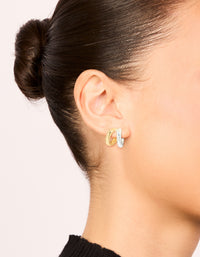 Showcasing mixed metal plated double hoop earrings in gold and silver with hoop closure on ear view - link has visual effect only