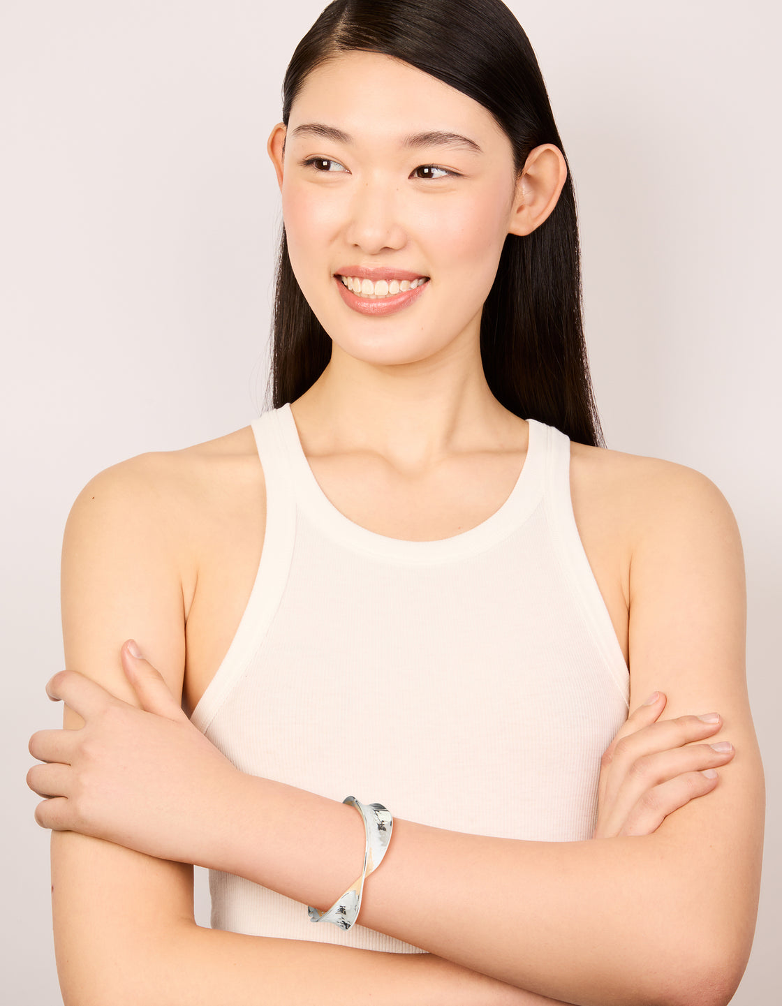 Crafted from silver plated hammered twist hinged bangle on model view