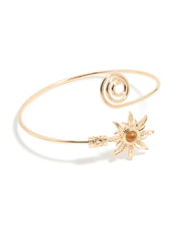 Featuring celestial sun detailing and a swirl design, this gold statement cuff is shown in front view - link has visual effect only