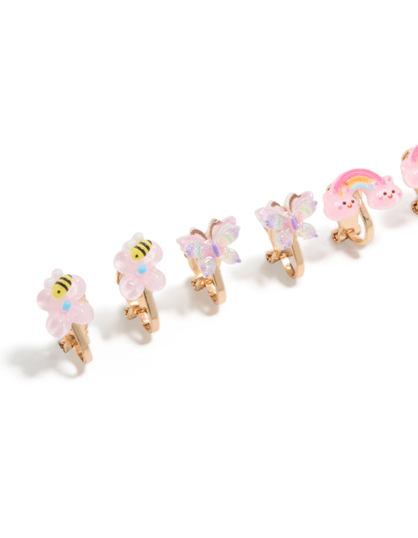 Featuring kids gold garden clip on earrings with celestial, butterfly, floral and glitter elements in pink aqua yellow close up view