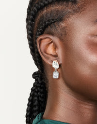 Showcasing silver and gunmetal plated cubic zirconia square drop earrings with statement style on ear view - link has visual effect only