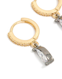 Showcasing mixed metal plated cubic zirconia oval huggie drop earrings in gold, silver, and clear tones close up view - link has visual effect only