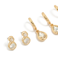 Featuring gold plated cubic zirconia large bezel set studs and huggie earrings in a 3-pack close up view - link has visual effect only