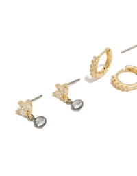 Showcasing mixed metal plated cubic zirconia bezel stud and huggie earrings in a 3-pack featuring gold, silver, and clear tones close up view - link has visual effect only