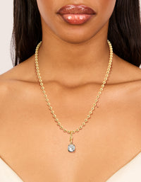 Featuring a mixed metal plated cubic zirconia pendant and ball chain necklace with crystal in gold on neck view - link has visual effect only