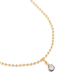 Showcasing a mixed metal plated cubic zirconia pendant and ball chain necklace with crystal in gold close up view - link has visual effect only