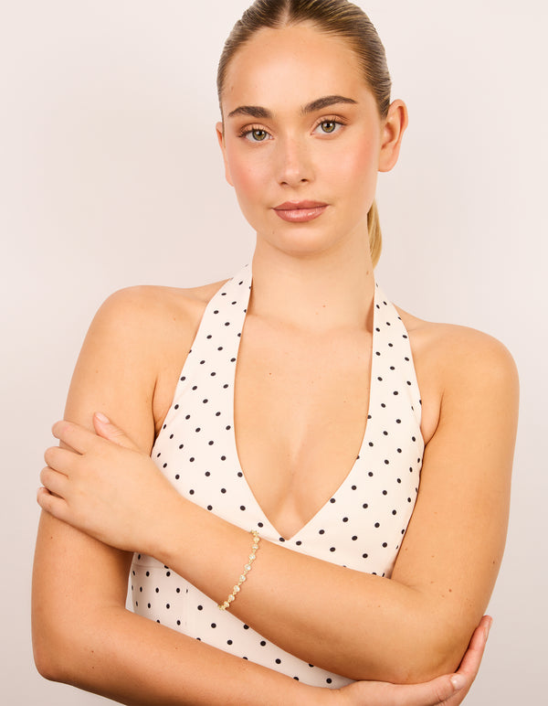 Designed with gold plated bezel cubic zirconia tennis bracelet on model view