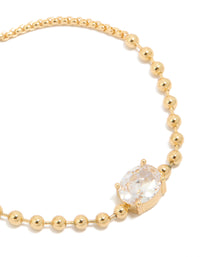 Showcasing gold ball and cubic zirconia oval toggle chain bracelet with gold plated finish close up view - link has visual effect only