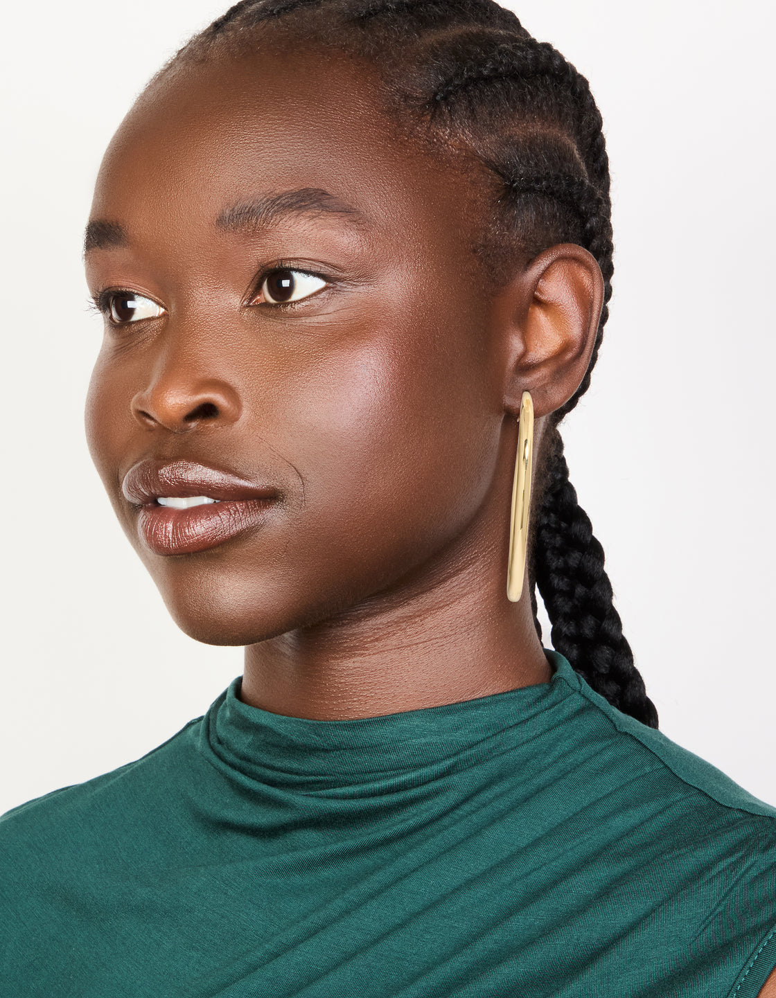 Designed with gold plated large hoop earrings featuring closure in gold on model view