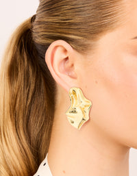 Showcasing gold plated wavy organic drop stud earrings on ear view - link has visual effect only